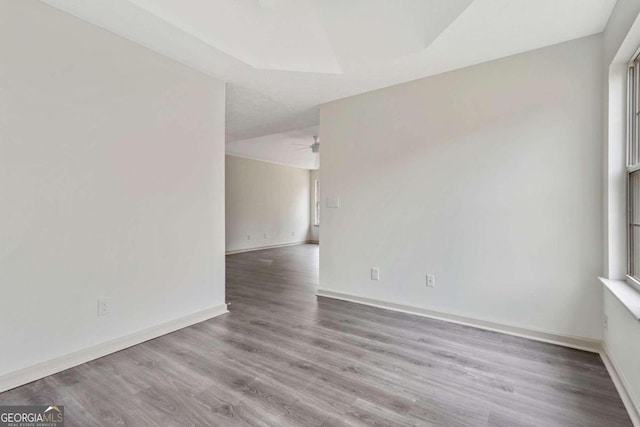 unfurnished room with ceiling fan and wood-type flooring