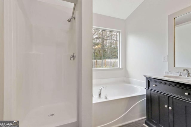 bathroom featuring vanity, plus walk in shower, and vaulted ceiling