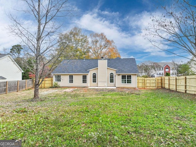 rear view of house with a lawn