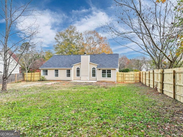 back of house featuring a lawn