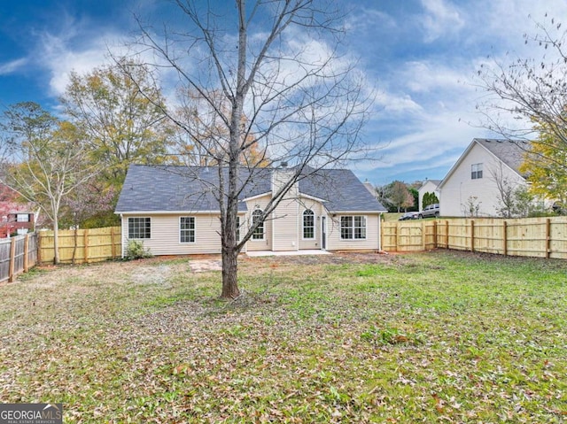 rear view of house with a yard