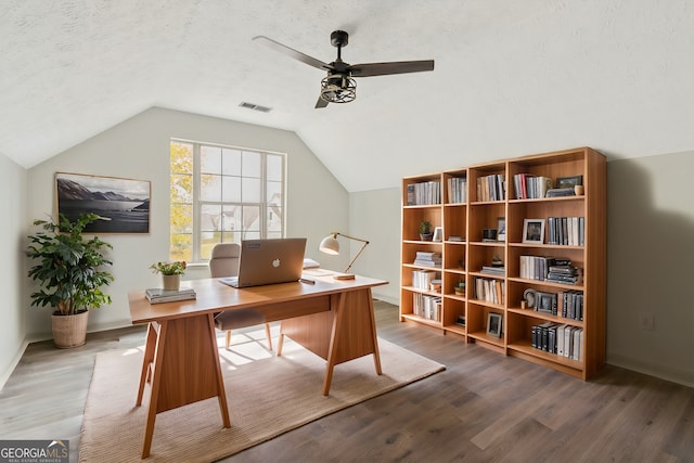 home office with vaulted ceiling, ceiling fan, a textured ceiling, and hardwood / wood-style flooring