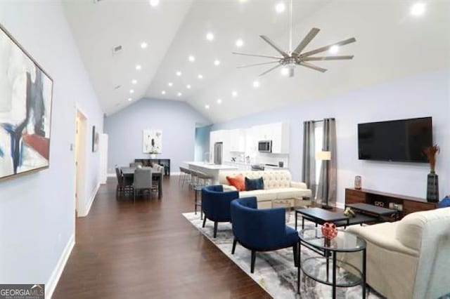 living room featuring ceiling fan, high vaulted ceiling, and dark hardwood / wood-style floors