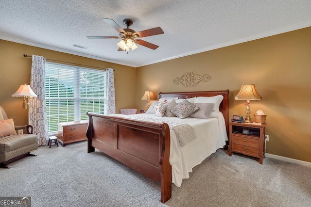 bedroom with ceiling fan, light carpet, a textured ceiling, and ornamental molding