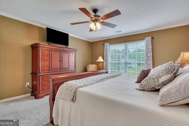 bedroom featuring carpet flooring, ceiling fan, a textured ceiling, and ornamental molding