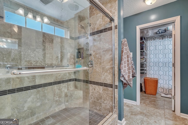 bathroom with a textured ceiling and walk in shower