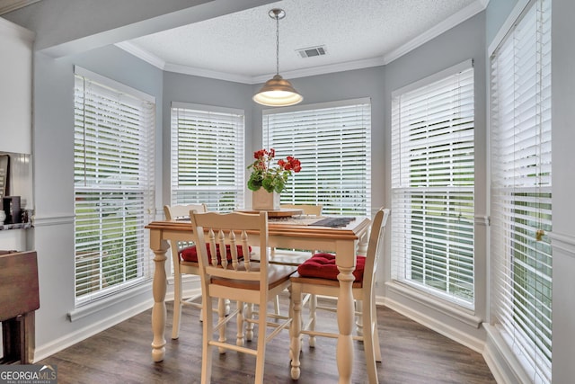 dining area featuring a textured ceiling, crown molding, plenty of natural light, and dark wood-type flooring