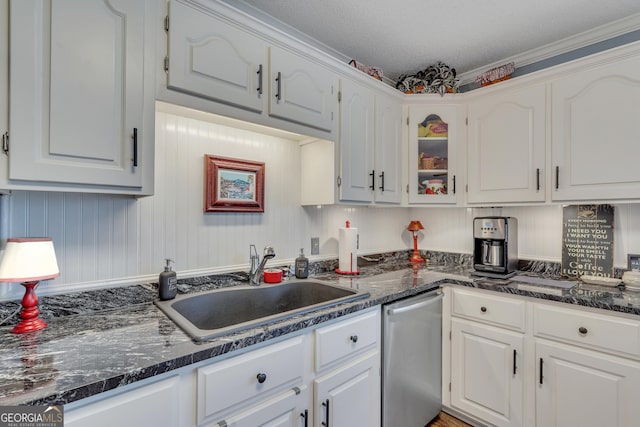 kitchen with sink, white cabinets, and a textured ceiling