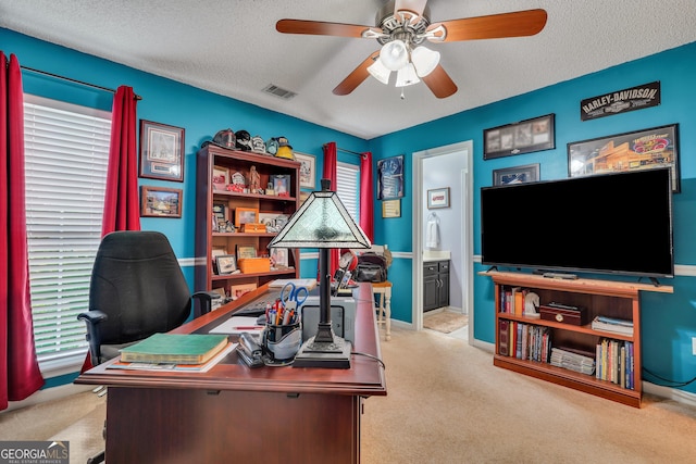 office with ceiling fan, light colored carpet, and a textured ceiling