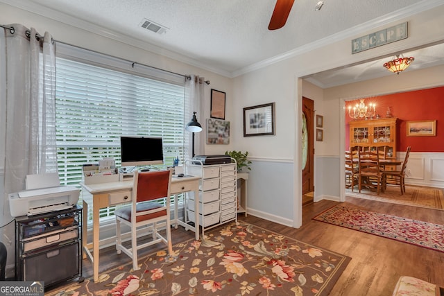 office with ceiling fan with notable chandelier, crown molding, wood-type flooring, and a textured ceiling