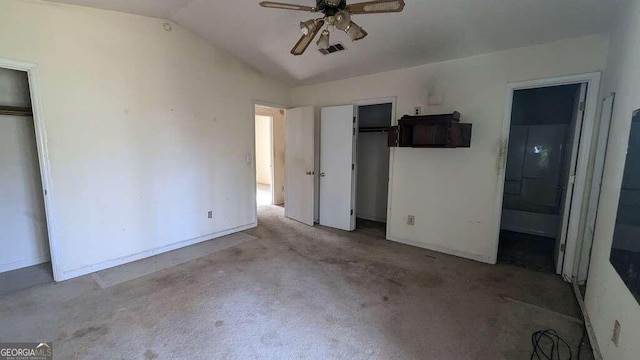 unfurnished bedroom with connected bathroom, ceiling fan, and lofted ceiling