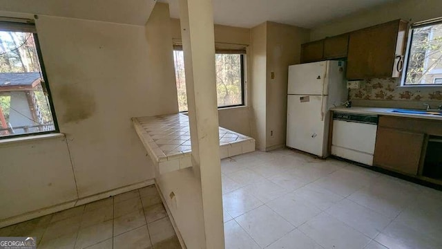 kitchen featuring sink and white appliances