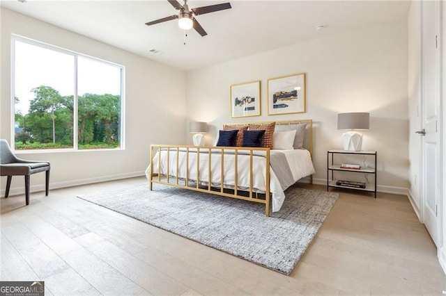 bedroom with hardwood / wood-style flooring and ceiling fan