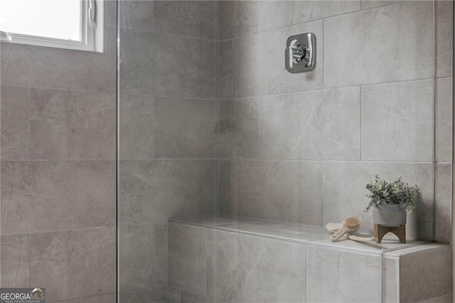 bathroom with a tile shower