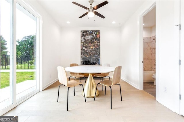 tiled dining area with ceiling fan