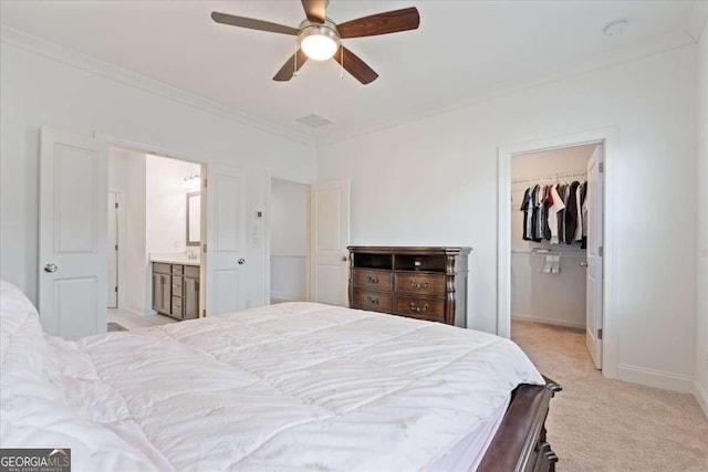 bedroom featuring ensuite bathroom, ceiling fan, a spacious closet, light colored carpet, and a closet