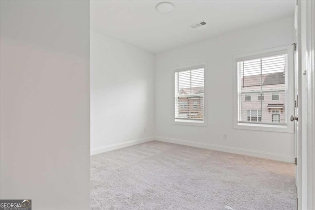 carpeted spare room with a healthy amount of sunlight