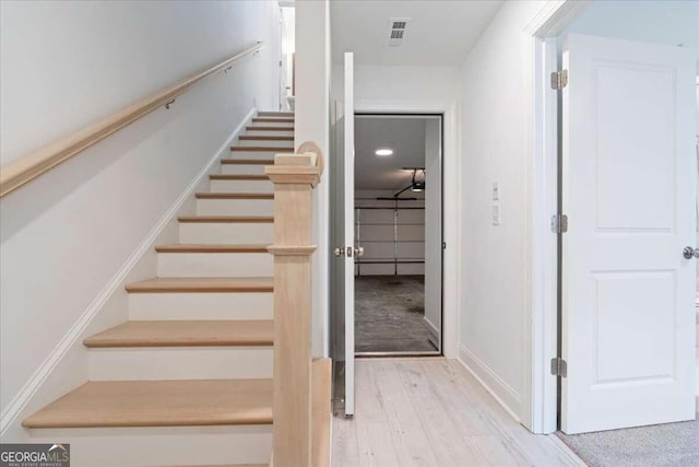 stairway featuring hardwood / wood-style floors