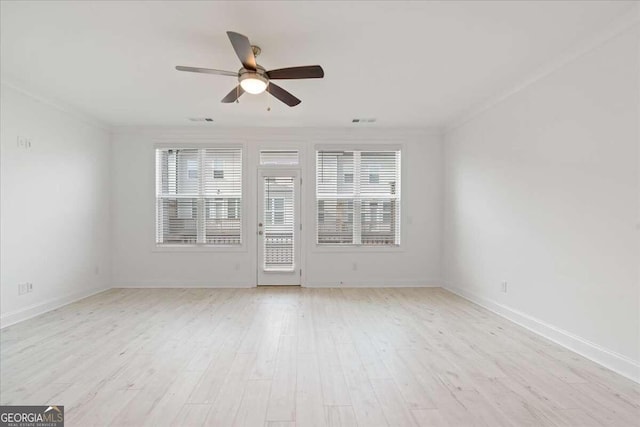 empty room with light hardwood / wood-style floors, plenty of natural light, ornamental molding, and ceiling fan