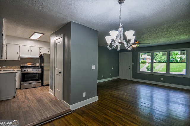 kitchen with dark hardwood / wood-style flooring, white cabinetry, sink, and appliances with stainless steel finishes