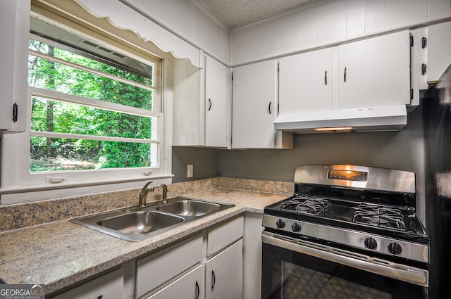 kitchen with sink, white cabinets, a textured ceiling, and stainless steel range with gas stovetop