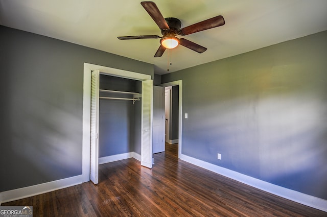 unfurnished bedroom featuring a closet, dark hardwood / wood-style floors, and ceiling fan