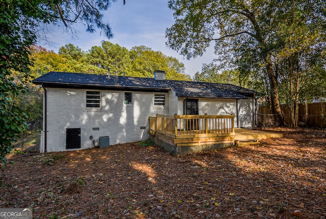 back of property with central AC and a deck