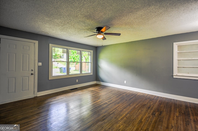 unfurnished room featuring a textured ceiling, built in shelves, ceiling fan, and dark hardwood / wood-style floors