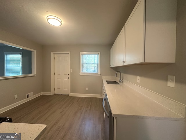 laundry area with dark hardwood / wood-style flooring and sink