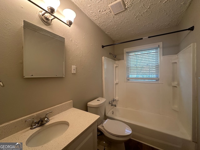 full bathroom featuring vanity,  shower combination, toilet, and a textured ceiling