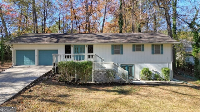 view of front of home with a garage and a front lawn