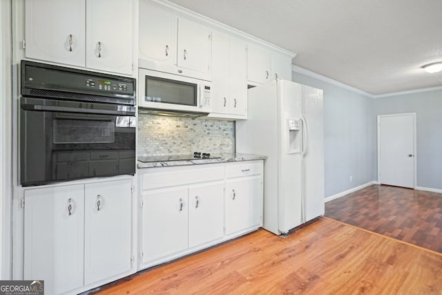 kitchen featuring light hardwood / wood-style flooring, backsplash, crown molding, white cabinets, and black appliances