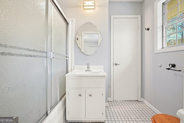 bathroom featuring vanity and combined bath / shower with glass door