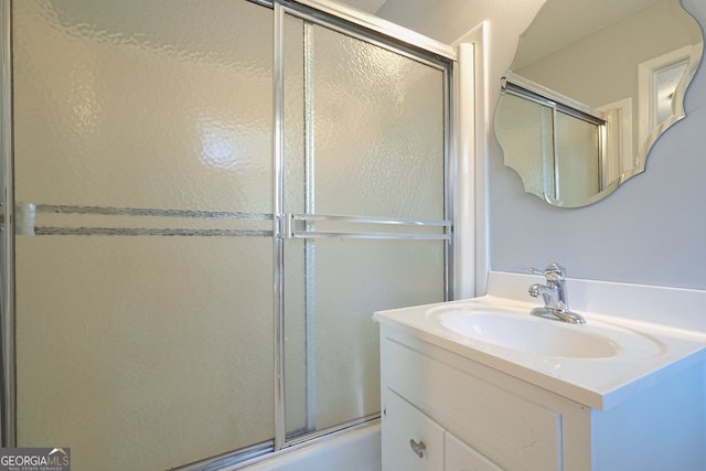 bathroom with vanity and combined bath / shower with glass door