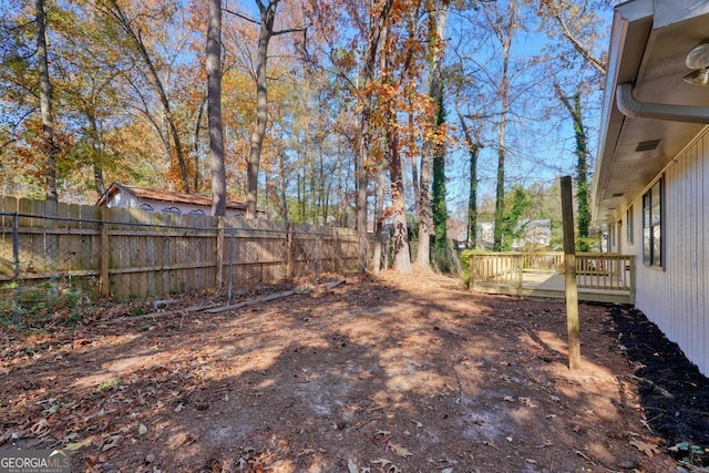 view of yard with a wooden deck