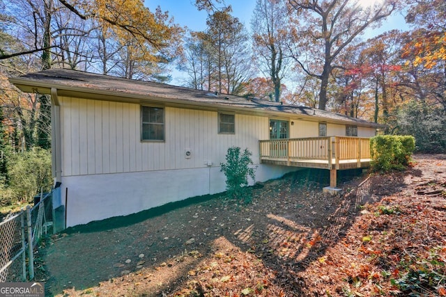 back of house featuring a wooden deck