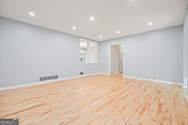 spare room featuring light hardwood / wood-style flooring