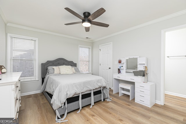 bedroom with ceiling fan, crown molding, and light hardwood / wood-style floors