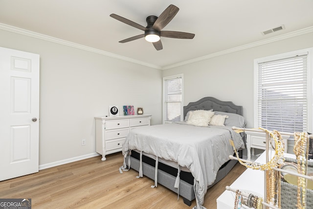 bedroom with light hardwood / wood-style flooring, ceiling fan, and ornamental molding