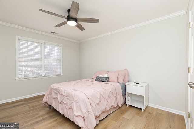 bedroom with light hardwood / wood-style flooring, ceiling fan, and crown molding