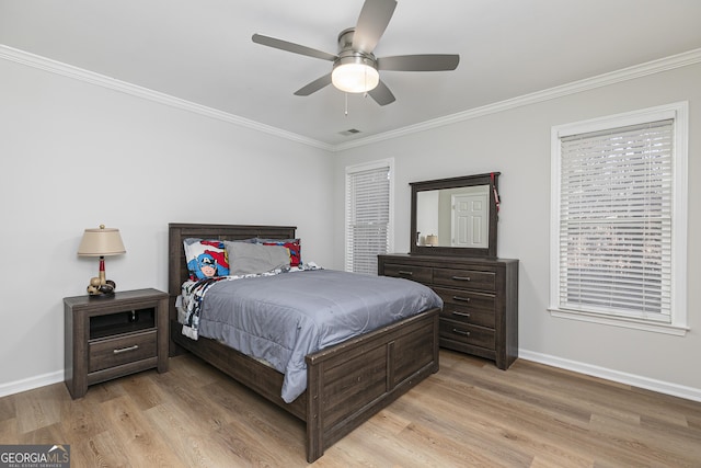 bedroom featuring ceiling fan, light hardwood / wood-style floors, and crown molding