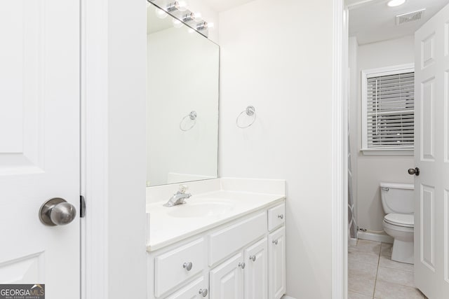 bathroom with tile patterned floors, vanity, and toilet