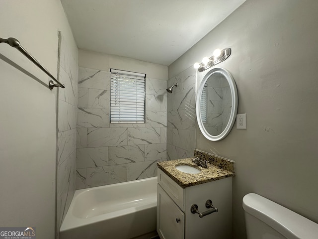 full bathroom featuring tiled shower / bath combo, toilet, and vanity