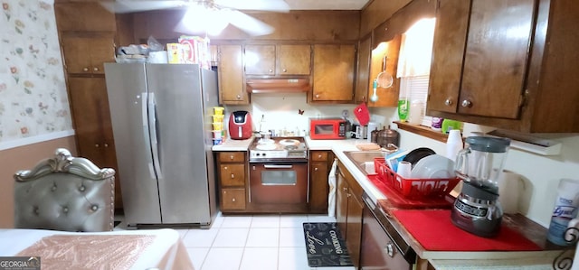 kitchen featuring stainless steel appliances, extractor fan, ceiling fan, sink, and light tile patterned floors