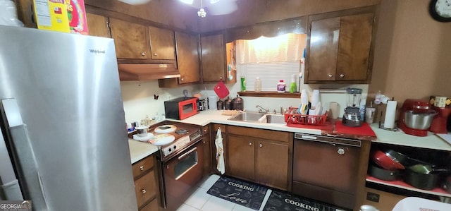 kitchen featuring light tile patterned floors, sink, and black appliances