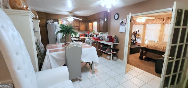 dining space featuring light tile patterned floors and ceiling fan