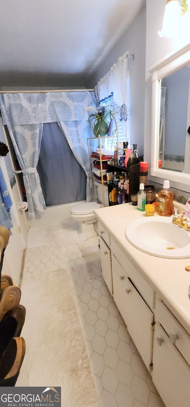 bathroom with tile patterned floors, vanity, and toilet