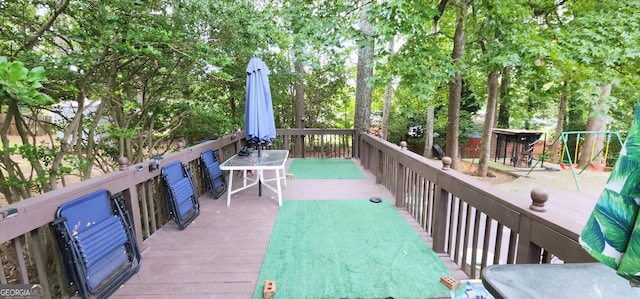 wooden terrace with a playground