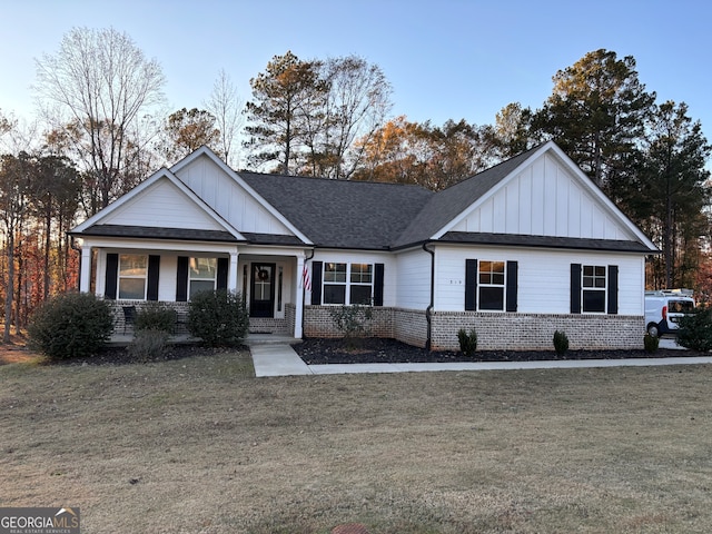 view of front of property with covered porch and a front yard