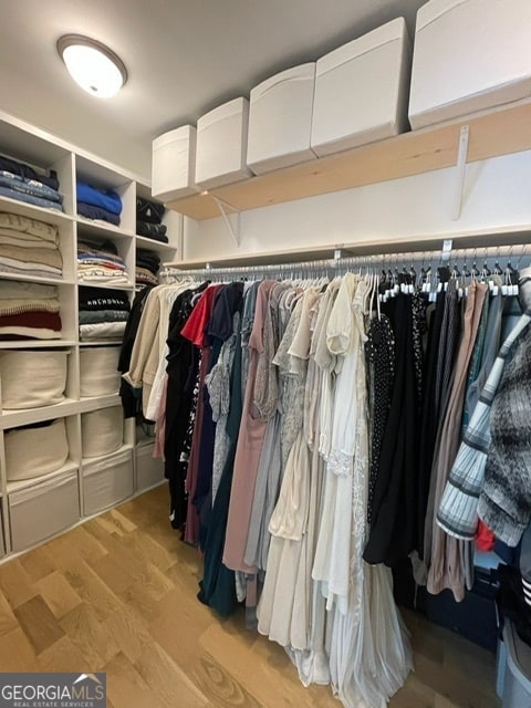 spacious closet with light hardwood / wood-style flooring